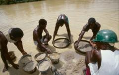 Miners working in an informal diamond mine in Sierra Leone