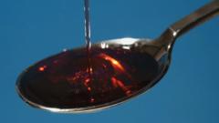 Cough syrup poured onto spoon, close-up