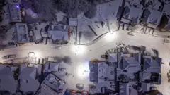 Getty Images Snow and sub-zero temperatures covered homes in Northwich, Cheshire on Monday in an aerial image - showing roads and roofs covered in white.