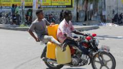 People ride a motorcycle with empty gasoline containers during a nationwide strike against rising fuel prices, in Port-au-Prince, Haiti September 26, 2022