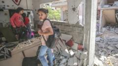 Palestinian girls inspect a destroyed house in Gaza