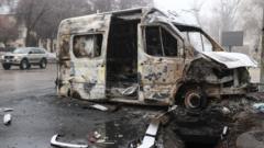 A burnt minibus pictured in a street in Kazakhstan's main city, Almaty