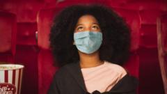 Girl wearing a mask in cinema