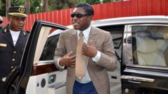 A picture taken on June 25, 2013 shows Teodorin Nguema Obiang (R), the son of Equatorial Guinea's president Teodoro Obiang and the country's vice-president in charge of security and defence, arriving at Malabo's Cathdral to celebrate his 41st birthday.