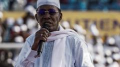 Chadian President Idriss Deby Itno holds his notes as he addresses supporters at his election campaign rally in N'Djamena on April 9, 2021