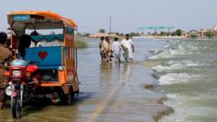 Flooded road with stranded travellers in Pakistan