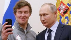 A member of the Russian 2018 Winter Olympics team takes a selfie with President Vladimir Putin at the Kremlin
