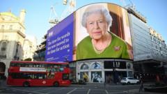 A screen displays an image of Britain"s Queen Elizabeth and a quotation from her COP26 Evening Address at Piccadilly Circus in London, Britain, 03 November 2021