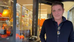Shopkeeper Cerubino Fry standing outside of his store