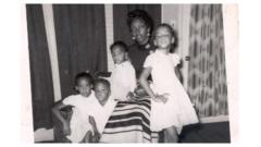 Mother and children posing for a photo at home