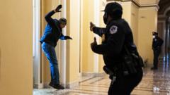A U.S. Capitol Police officer maces a Trump rioter who broke through a window on the first floor of the Capitol on Wednesday, Jan. 6, 2021.