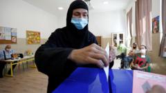 A woman wearing a face mask casts her vote in Montenegro