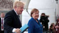 Boris Johnson is greeted by Angela Merkel as he arrives in Berlin for a summit about Libya, in January 2020