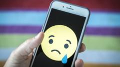 A sad emoji on a phone