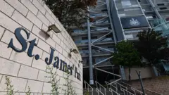 St James' Park in Newcastle. The name of the grounds is on a wall, while the club's logo is displayed on the stadium.