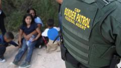 Central American asylum seekers wait as US Border Patrol agents take them into custody near McAllen, Texas, on 12 June 2018