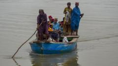 Stranded people are evacuated on boats in Sukkur
