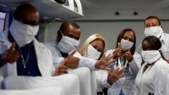A group of doctors in Havana pose for a picture inside a plane headed to South Africa - 25 April 2020.