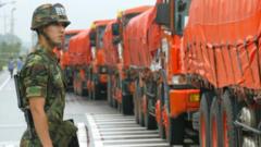 South Korea solider stands near trucks