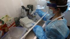 A scientist works at a laboratory analysing coronavirus swabs in Glasgow, Scotland (10 June 2020)