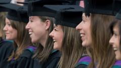 Students posing for celebration photographs after a graduation ceremony at Edge Hill University, Ormskirk, Lancashire