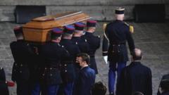 The coffin of slain teacher Samuel Paty is carried in the courtyard of the Sorbonne university