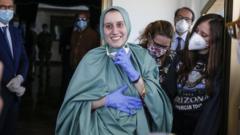 Silvia Romano (centre) smiles after arriving at Rome's airport, Italy. Photo: 10 May 2020