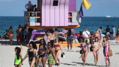Young people on the beach in Miami celebrate their holidays despite warnings about coronavirus