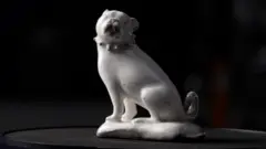 Tony Jolliffe BBC A complete figurine of a seated pug dog in plain white glazed porcelain with details picked out in black found at St James' Euston
