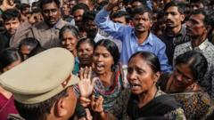 People argue with police over a protest against the alleged rape and murder of a 27-year-old woman
