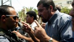 Israeli Arabs argue with police officers after they mechanically detonated a bomb without warning causing slight damage to their houses June 25, 2003 in Kfar Kassem, Israel.
