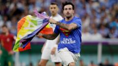 Pitch invader with rainbow flag and Save Ukraine shirt during the World Cup
