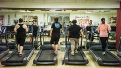 Four people use treadmills at the Aimin Fat Reduction Hospital in Tianjin, China, in 2015