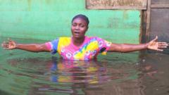 Shiphrah Timbiri singing in flood water in Ogbia Municipality, Bayelsa State, Nigeria - November 2022