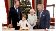 Queen Elizabeth II, the Prince of Wales, the Duke of Cambridge and Prince George preparing special Christmas puddings in the Music Room at Buckingham Palace, London, as part of the launch of the Royal British Legion's Together at Christmas initiative