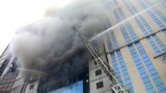 Firefighters attempt to extinguish a fire at a multi-storey commercial building in Dhaka, 28 March 2019