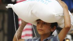 A boy carries food aid given by UN"s World Food Programme in Raqqa, Syria April 26, 2018