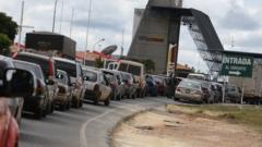 Venezuelans queue with their vehicles on the border with Brazil, as seen from the Venezuelan city of Santa Elena de Uairen, February 21, 2019