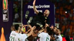 Algeria players carry dia coach shoulder high