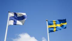 swedish and finnish flags waving