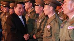 North Korea's leader Kim Jong Un greets military personnel at the Defence Development Exhibition, in Pyongyang, North Korea, in this undated photo released on 12 October 2021