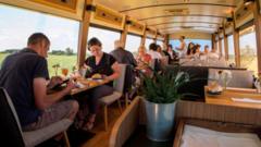 Clients eat aboard the itinerant gourmet restaurant in Pulverieres in central France