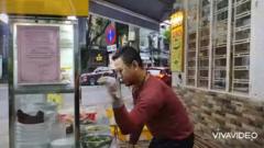 Noodle vendor Bui Tuan Lam prepares and seasons a bowl of beef noodles in the style of Turkish chef and social media star Nusret Gökçe, otherwise known as Salt Bae.
