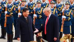 China's President Xi Jinping and US President Donald Trump (L-R front) shake hands during a meeting outside the Great Hall of the People in Beijing in 2017