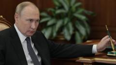 Vladimir Putin sits at a desk