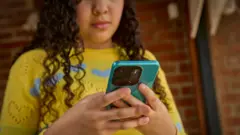 Getty Images Teenage girl using mobile phone