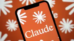 A logo of Claude on an iPhone, with a background of the company's star-like logo