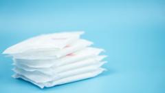 A pile of wrapped sanitary towels on a blue background