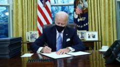 US President Joe Biden signs documents after being sworn-in