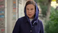 Lyse Doucet in a blue head scarf.